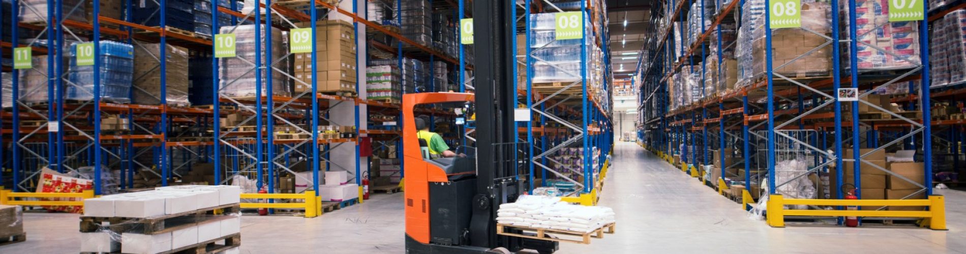 Industrial building large warehouse interior with forklift and palette with goods and shelves.